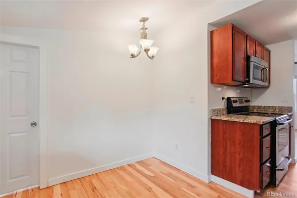 a kitchen with stainless steel appliances granite countertop a stove a sink and a microwave