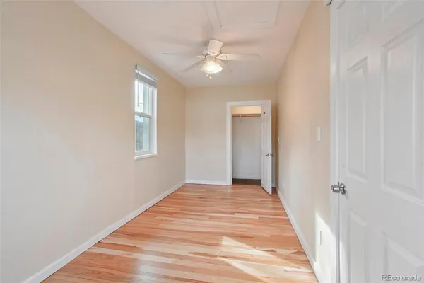 a view of a livingroom with a ceiling fan and wooden floor