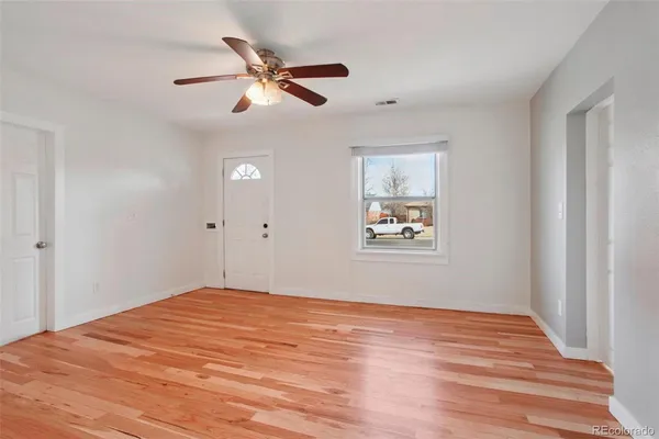 a view of an empty room with wooden floor