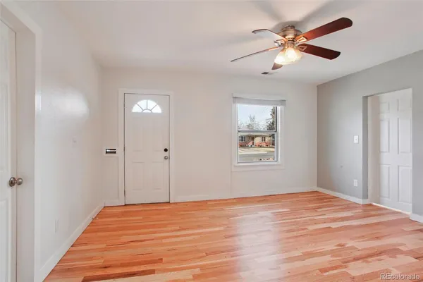 a view of a big room with wooden floor and windows in a room