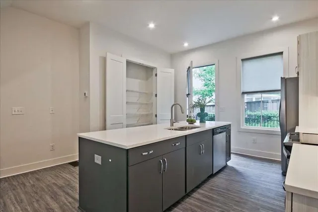 a kitchen with a sink a counter and cabinets
