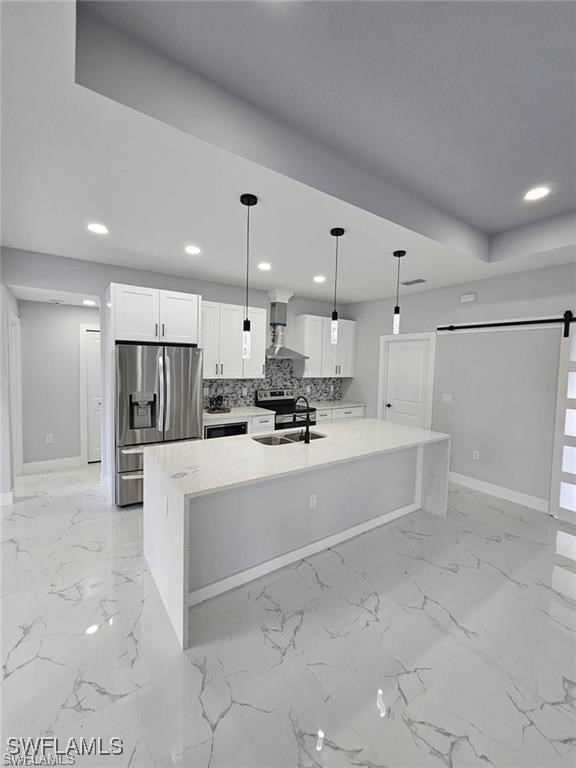 417 Progress Avenue Lehigh Acres, FL 33974 - Photo 13 of 25 a large white kitchen with kitchen island a sink a stove a refrigerator and white cabinets