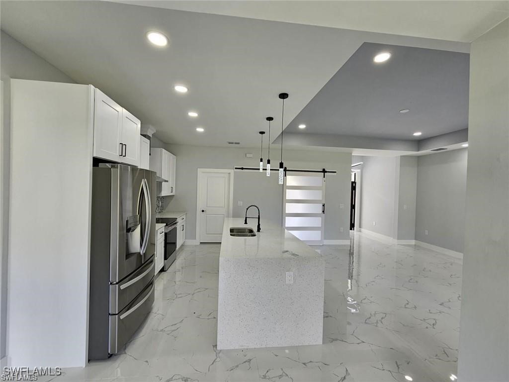 417 Progress Avenue Lehigh Acres, FL 33974 - Photo 14 of 25 a view of a refrigerator in kitchen and a window