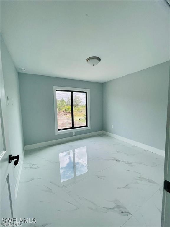 417 Progress Avenue Lehigh Acres, FL 33974 - Photo 15 of 25 an empty room with windows