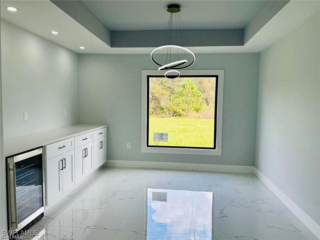417 Progress Avenue Lehigh Acres, FL 33974 - Photo 17 of 25 a bathroom with a granite countertop sink a window and a shower