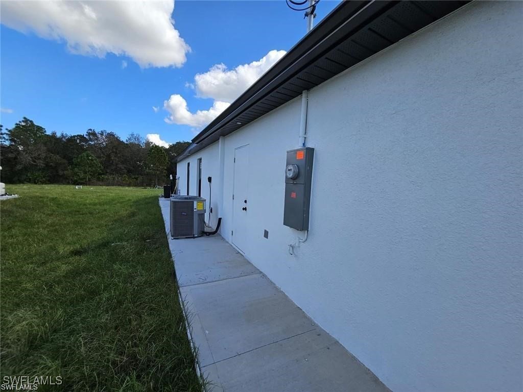 417 Progress Avenue Lehigh Acres, FL 33974 - Photo 23 of 25 a backyard of a house with lots of green space