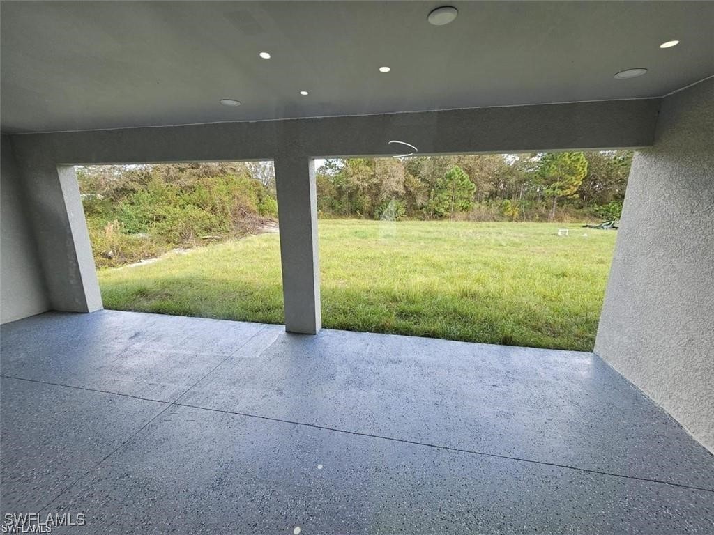 417 Progress Avenue Lehigh Acres, FL 33974 - Photo 24 of 25 a view of a big room with wooden floor and outdoor space