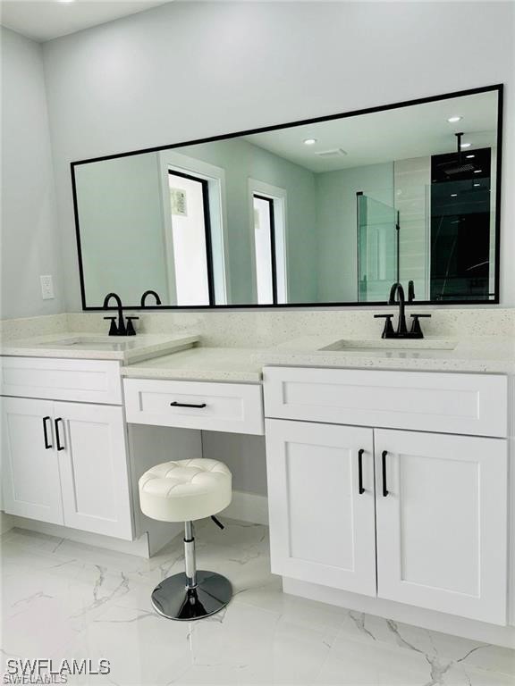 417 Progress Avenue Lehigh Acres, FL 33974 - Photo 7 of 25 a bathroom with a sink and a mirror