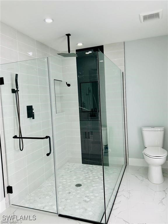 417 Progress Avenue Lehigh Acres, FL 33974 - Photo 8 of 25 a bathroom with a shower and toilet