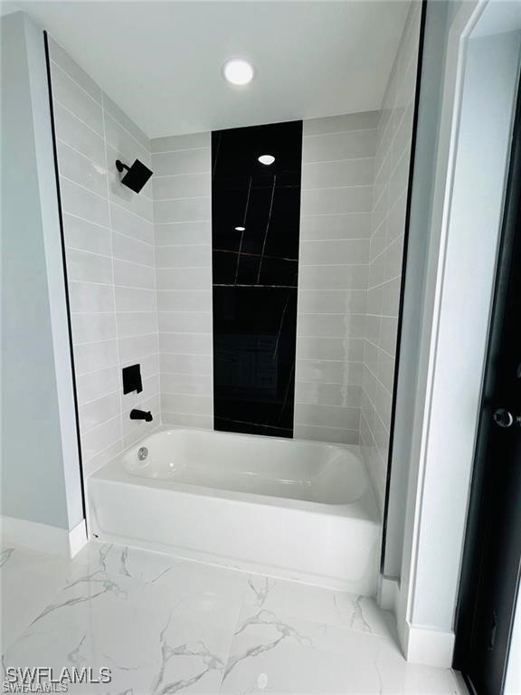 417 Progress Avenue Lehigh Acres, FL 33974 - Photo 9 of 25 a bathroom with a bathtub and a shower