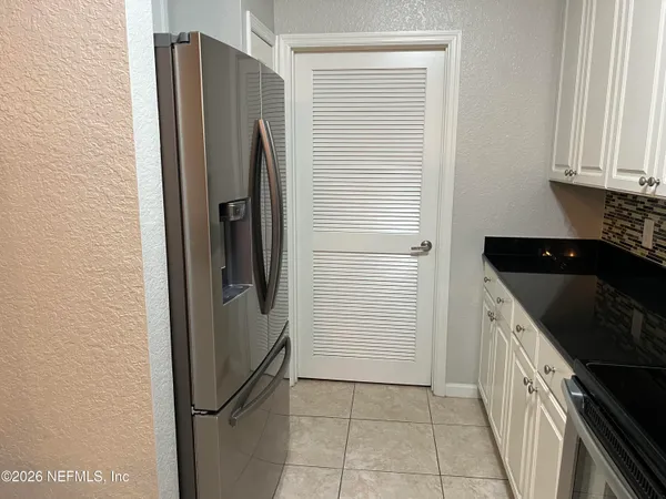 a kitchen with a refrigerator and cabinets
