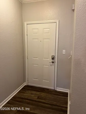 an empty room with wooden floor