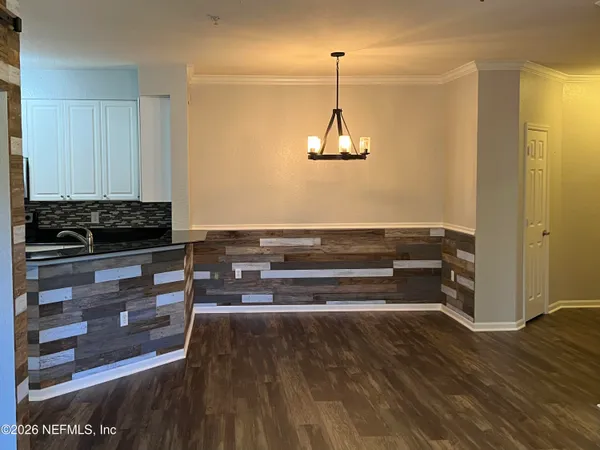 a view of room with wooden floor