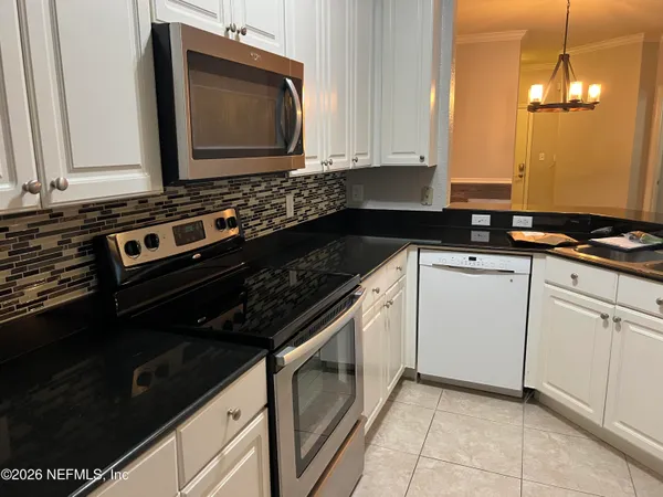 a kitchen with a stove and a microwave