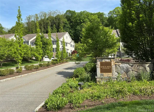 a view of a garden with a bench under an umbrella
