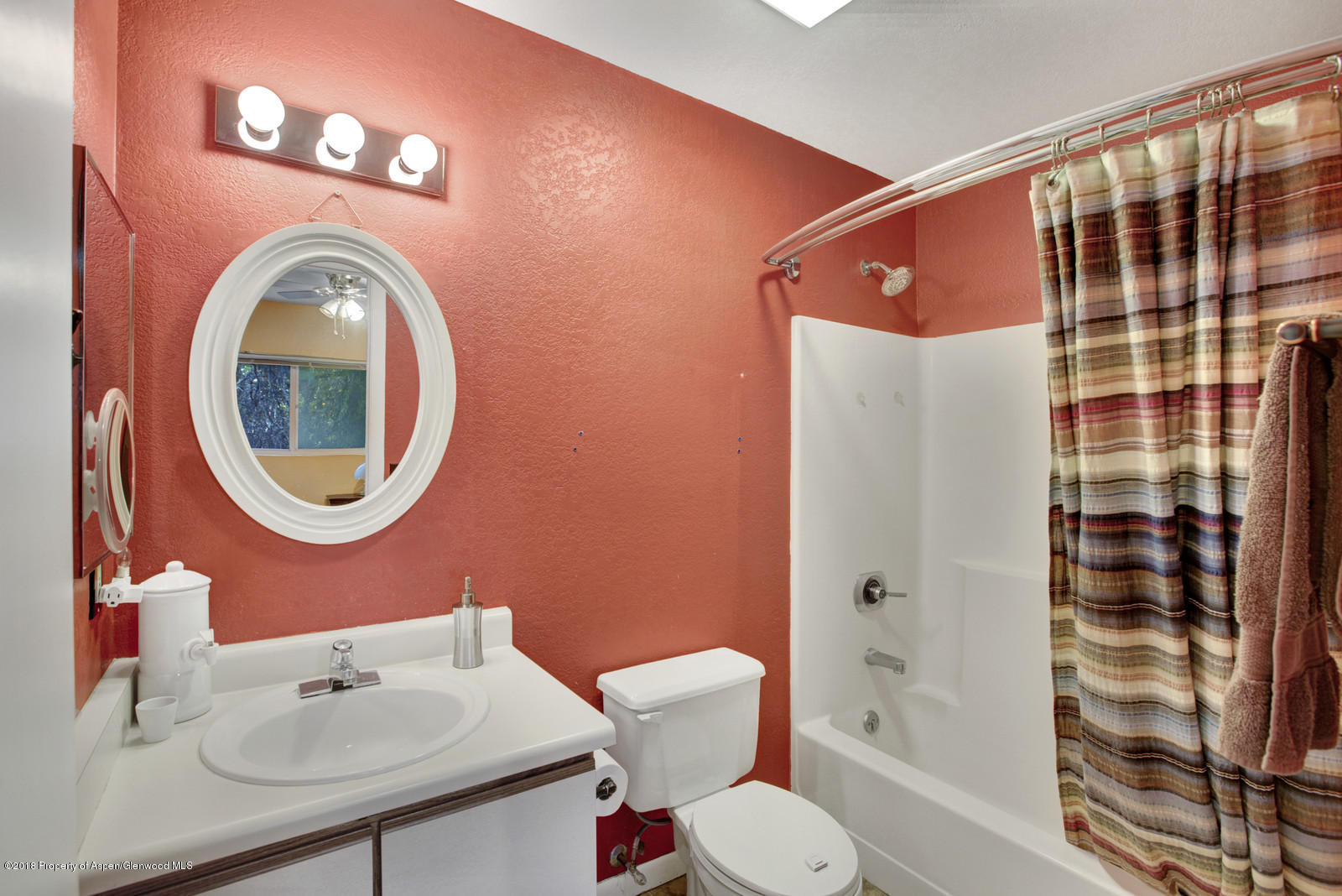 323 Park Avenue, Unit G2 Basalt, CO 81621 - Photo 11 of 16 a bathroom with a sink a mirror a toilet and shower