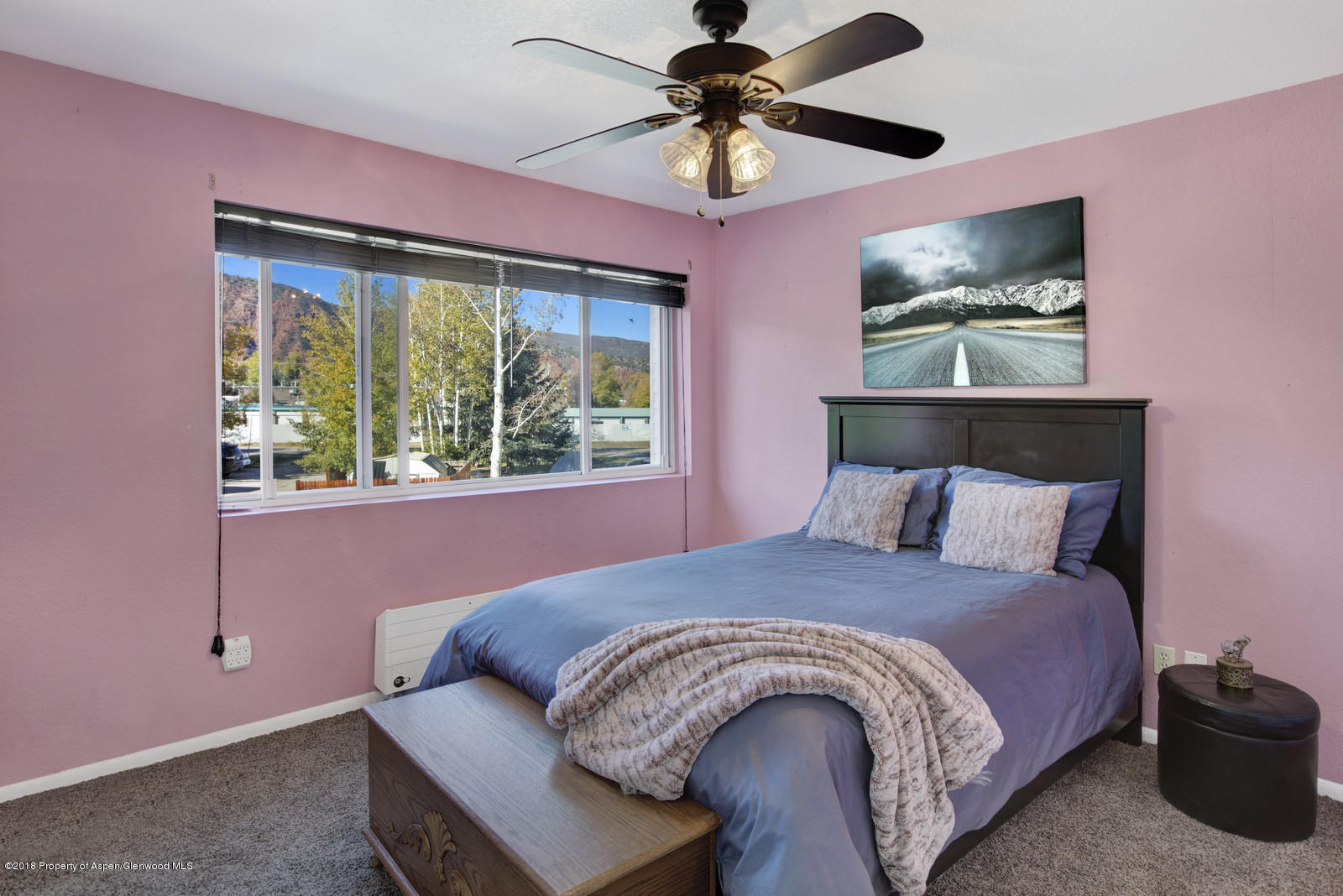 323 Park Avenue, Unit G2 Basalt, CO 81621 - Photo 12 of 16 a large bed sitting in a bedroom next to a window