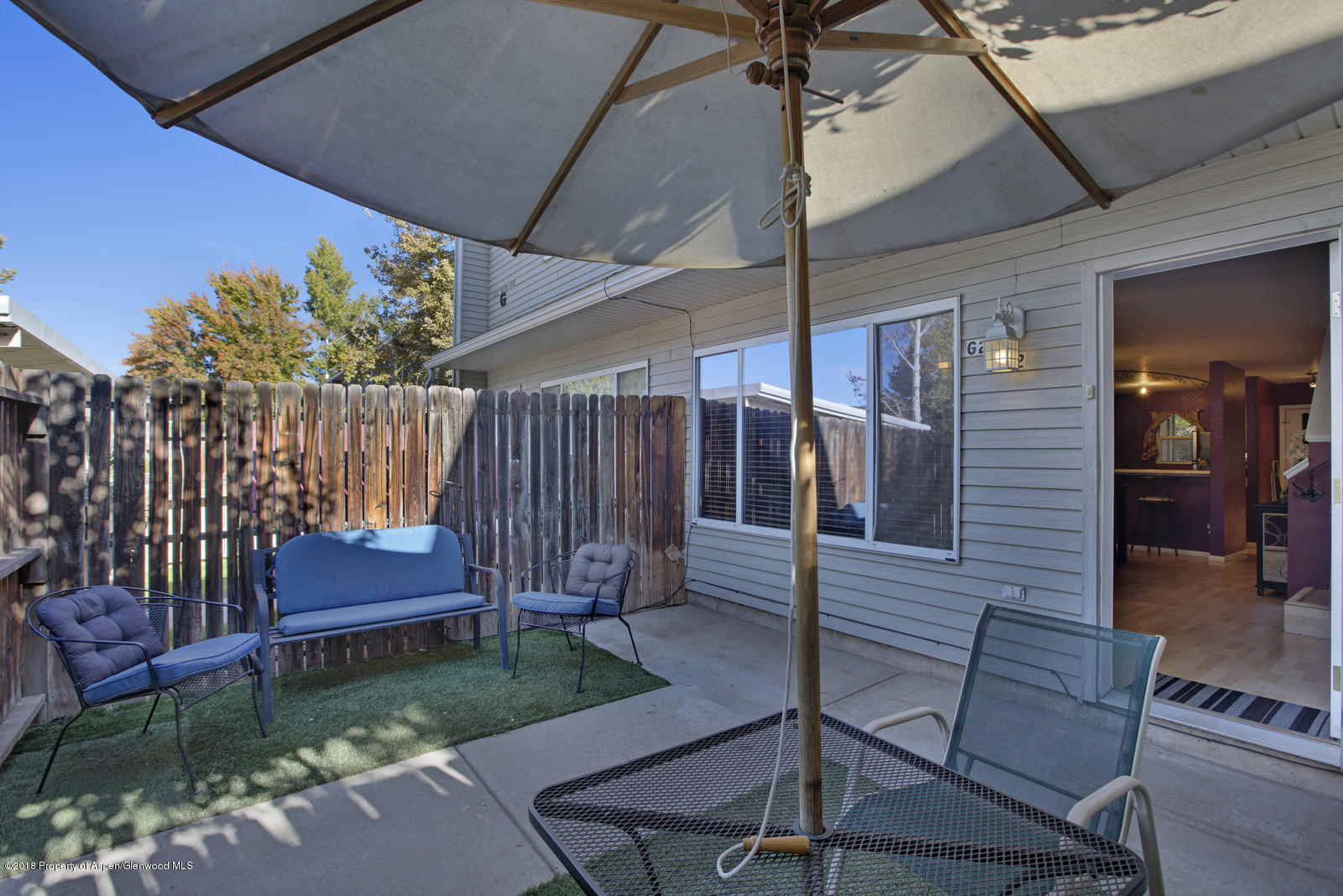 323 Park Avenue, Unit G2 Basalt, CO 81621 - Photo 15 of 16 a backyard of a house with a garden and outdoor seating