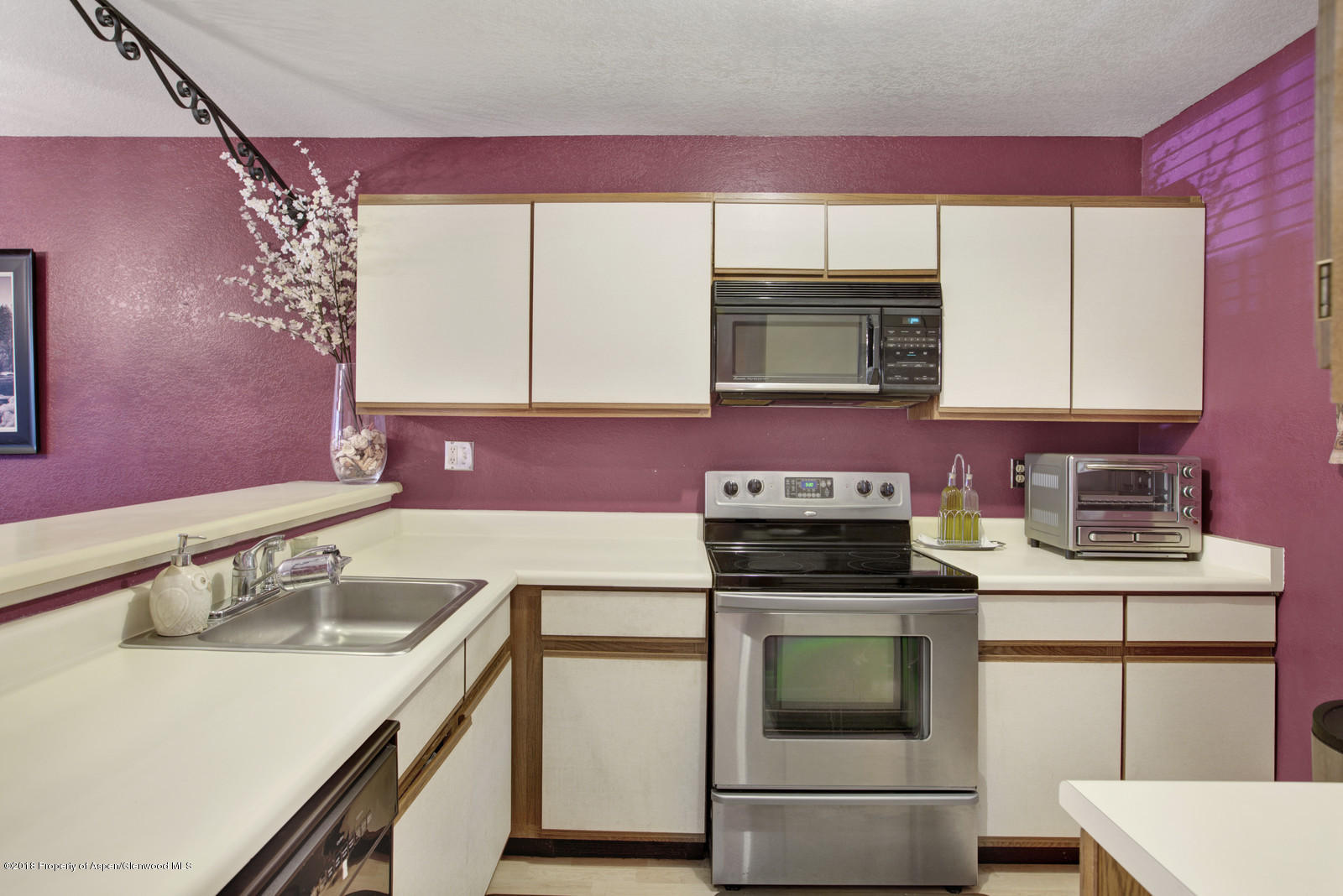 323 Park Avenue, Unit G2 Basalt, CO 81621 - Photo 6 of 16 a kitchen with a sink stove top oven and microwave
