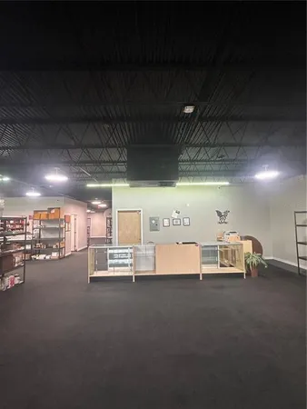 a view of a room with lots of wooden furniture and a garage