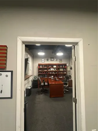 a room with furniture and a kitchen view