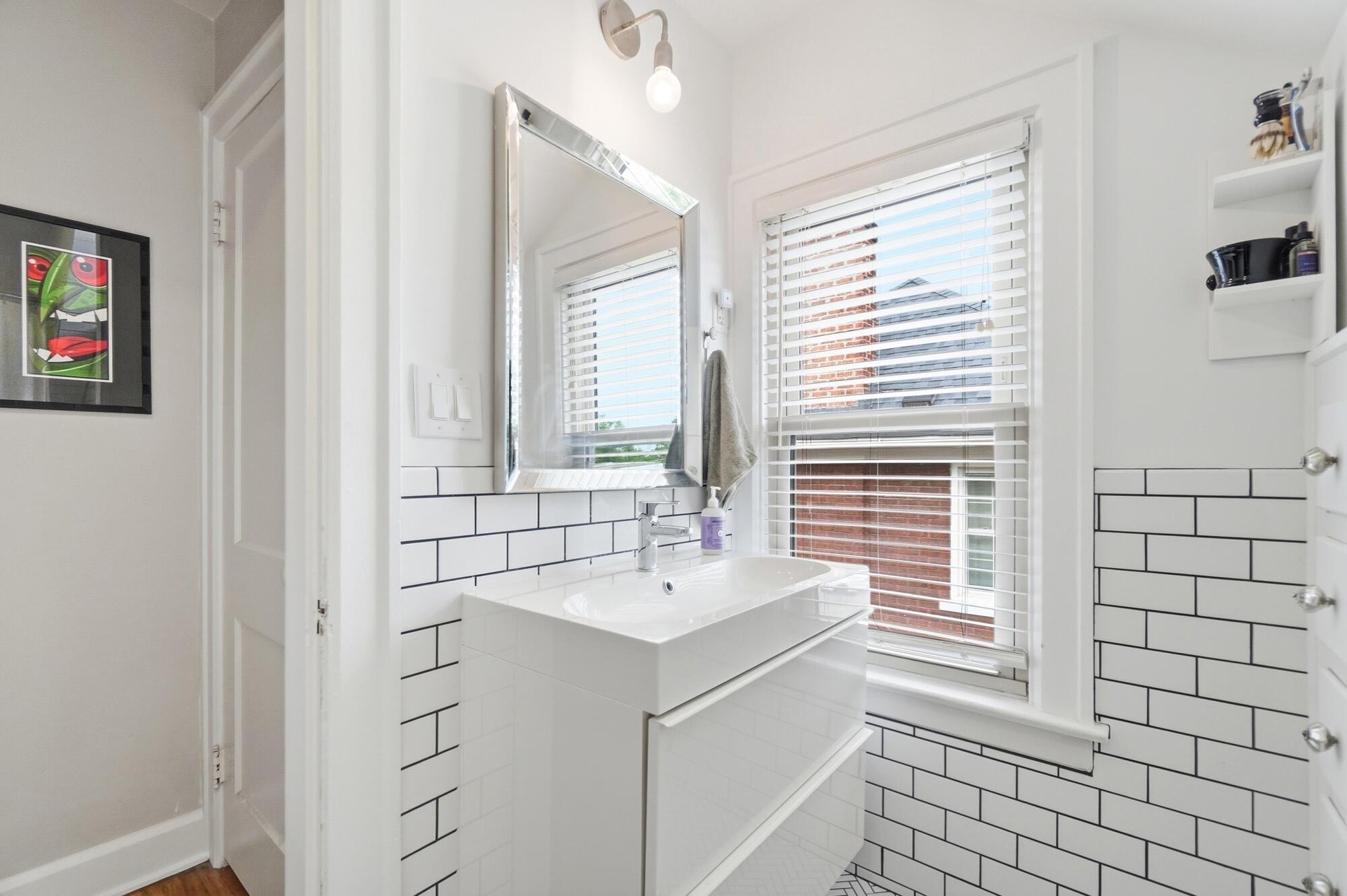214 Northridge Road Columbus, OH 43214 - Photo 29 of 37 The renovated full bath has subway tile, herringbone tile flooring and a nice size vanity.