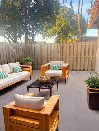 a backyard of a house with outdoor seating