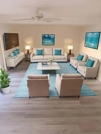 a living room with couches and a flat screen tv