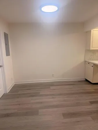 a view of an empty room and wooden floor