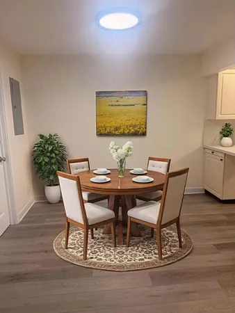 a dining room with furniture and wooden floor