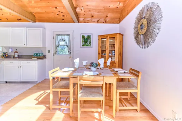 a dinning table and chairs in patio of a house