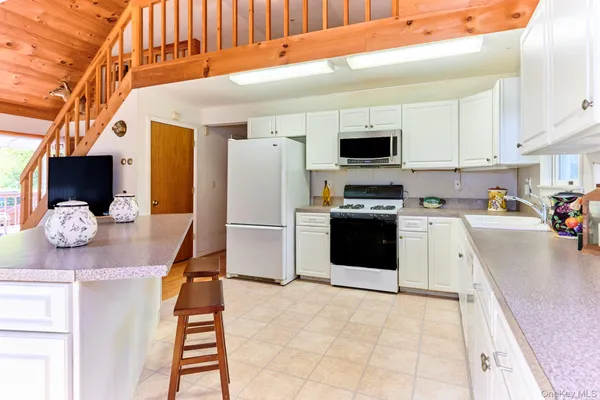 a kitchen with stainless steel appliances granite countertop a sink stove and cabinets