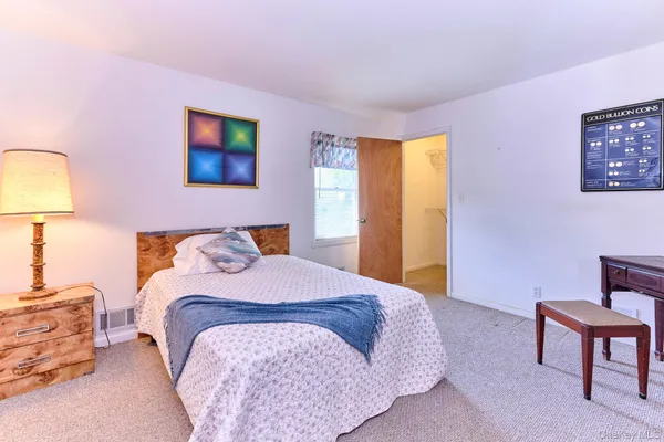 a bedroom with a bed and a lamp