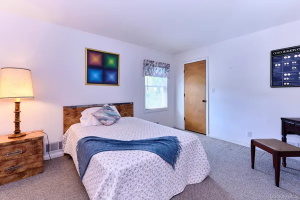 a bedroom with a bed and a dresser