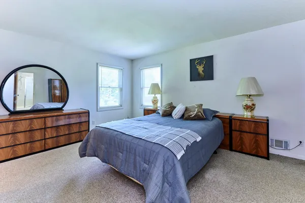 a bedroom with a large bed and a window