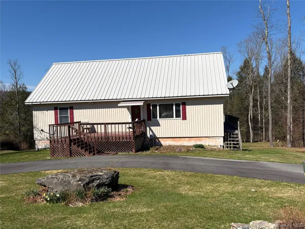 a living room with furniture a window and wooden floor