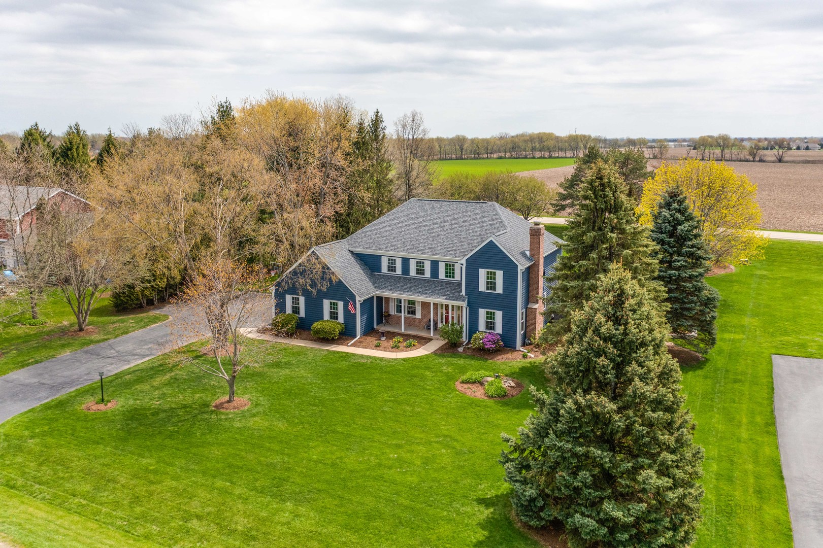 1603 Elm Street Spring Grove, IL 60081 - Photo 3 of 38 an aerial view of a house with a garden and lake view