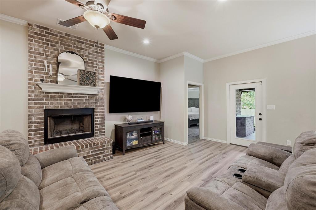 3020 West Loy Lake Road Denison, TX 75020 - Photo 4 of 32 Crown molding from top to bottom; and look at that wood burning fireplace!