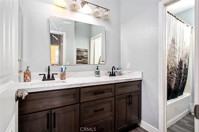 an aerial view of residential houses with outdoor space and parking