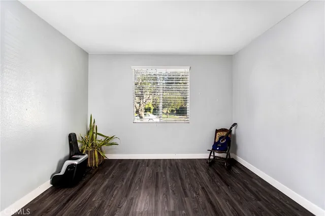 a view of room with window and wooden floor