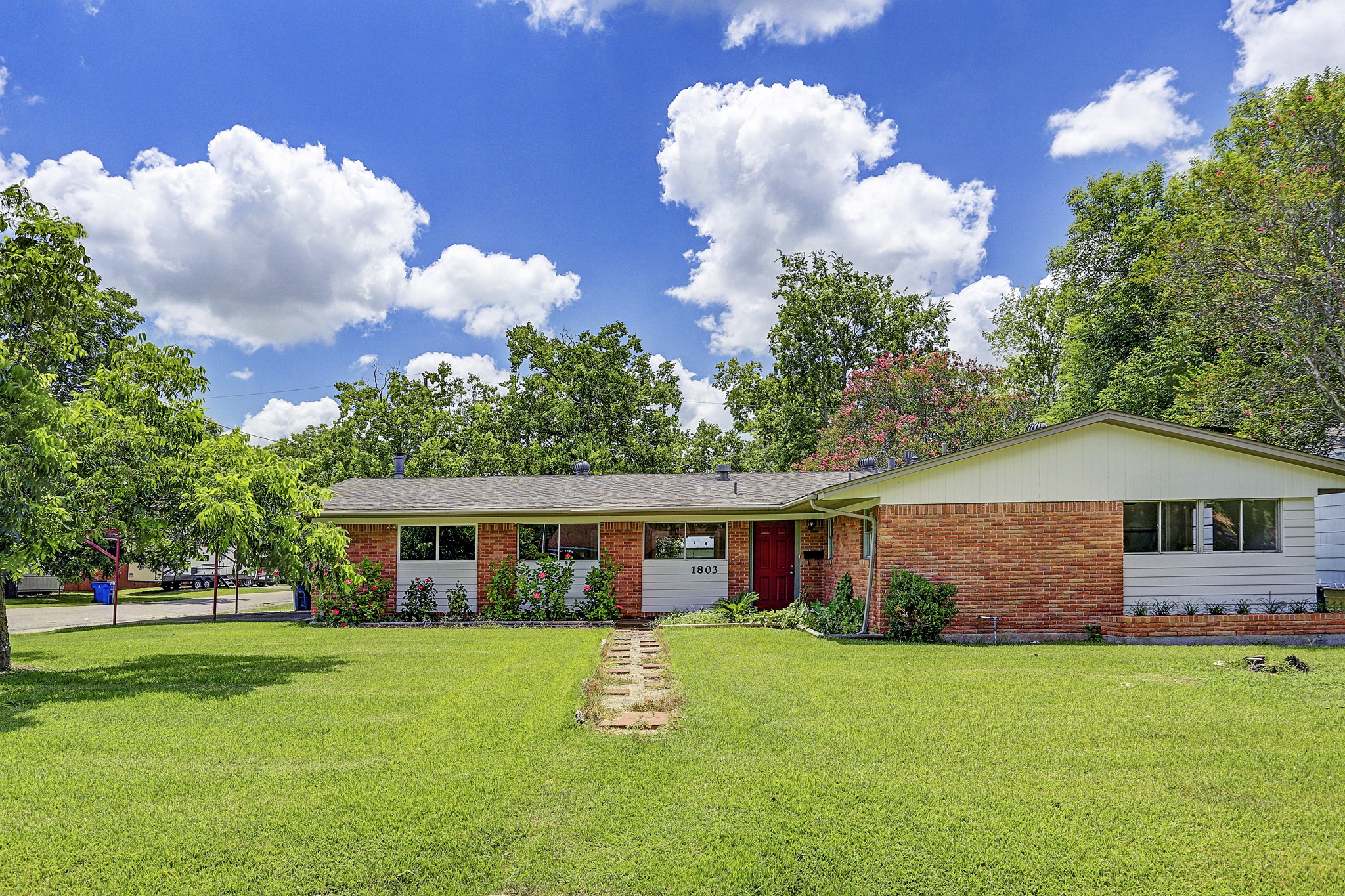 a front view of house with yard and green space