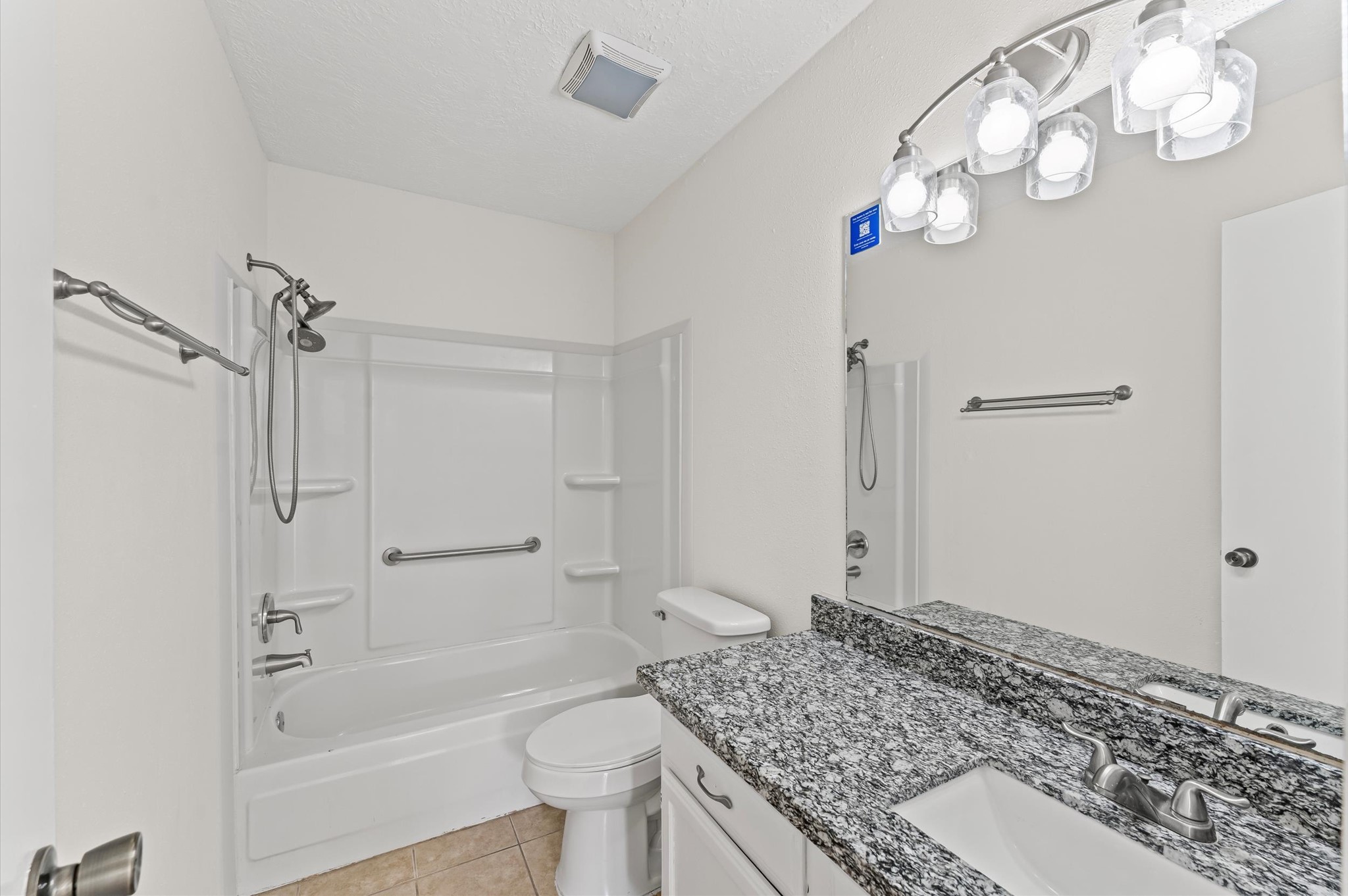 22935 Sherioaks Lane Spring, TX 77389 - Photo 12 of 22 a bathroom with a granite countertop sink a toilet and shower