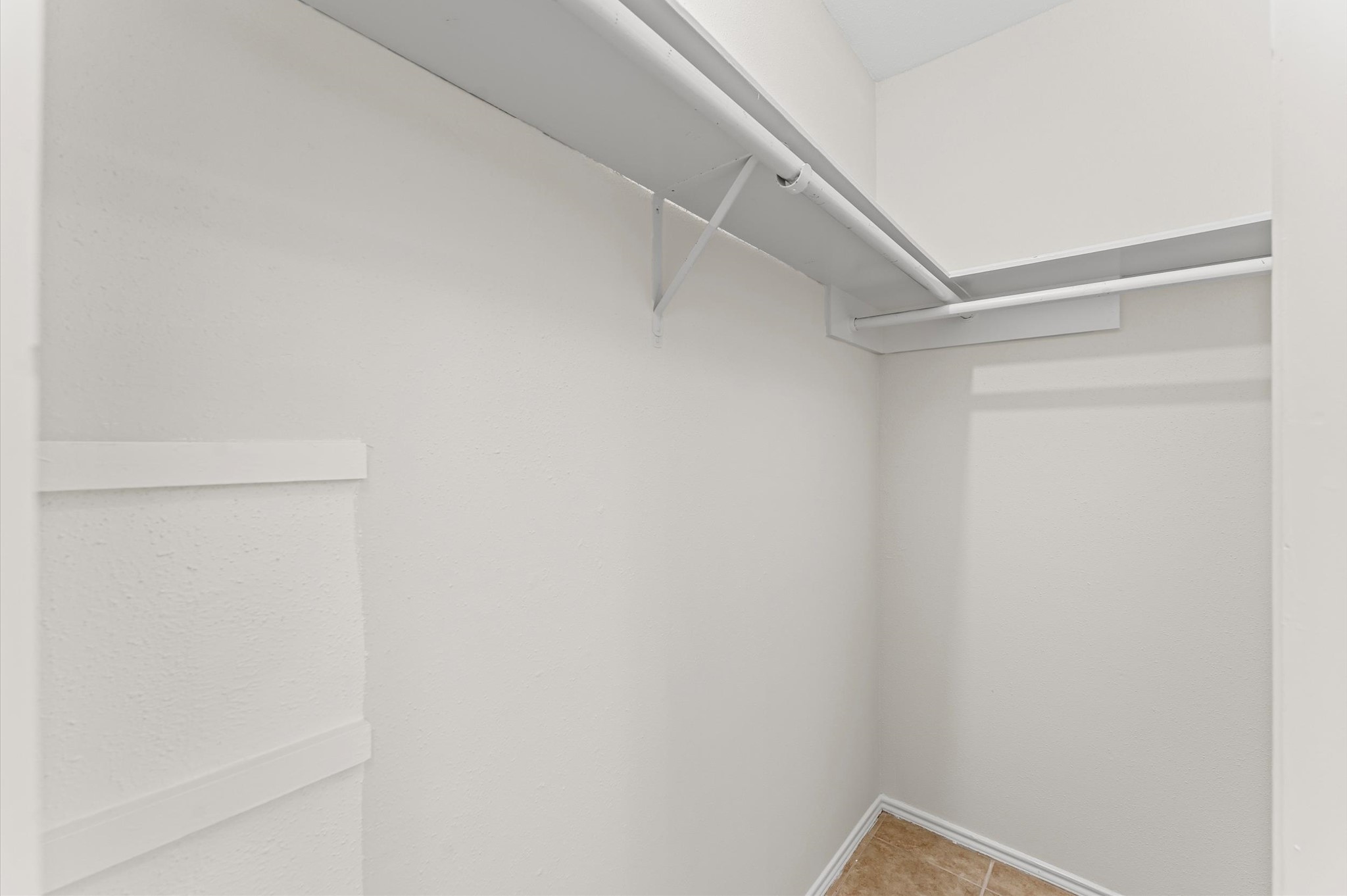 22935 Sherioaks Lane Spring, TX 77389 - Photo 18 of 22 a view of walk in closet with empty racks