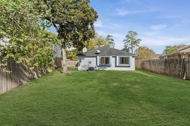 a view of a house with a backyard