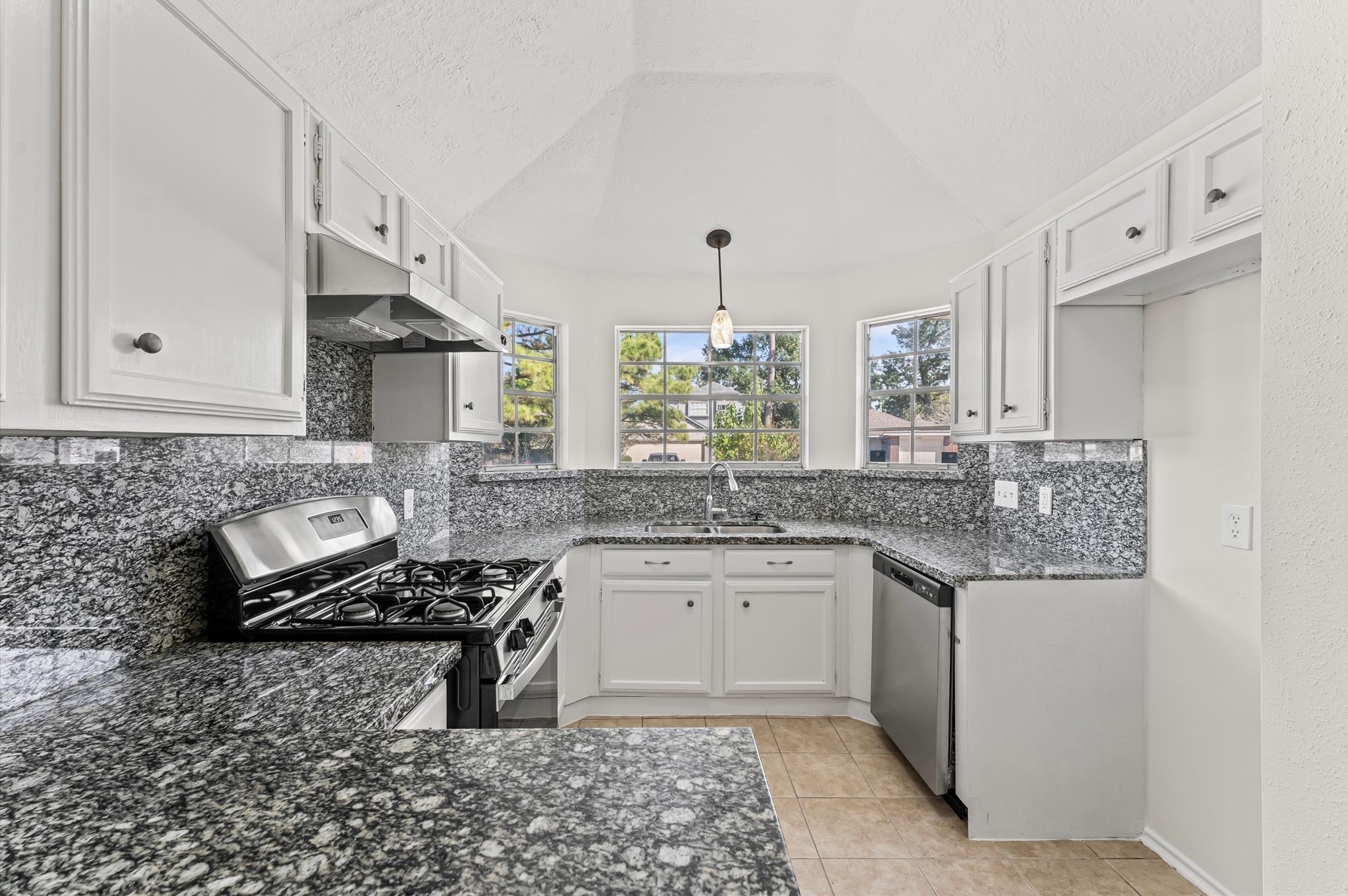 22935 Sherioaks Lane Spring, TX 77389 - Photo 10 of 22 a kitchen with a sink stove and cabinets