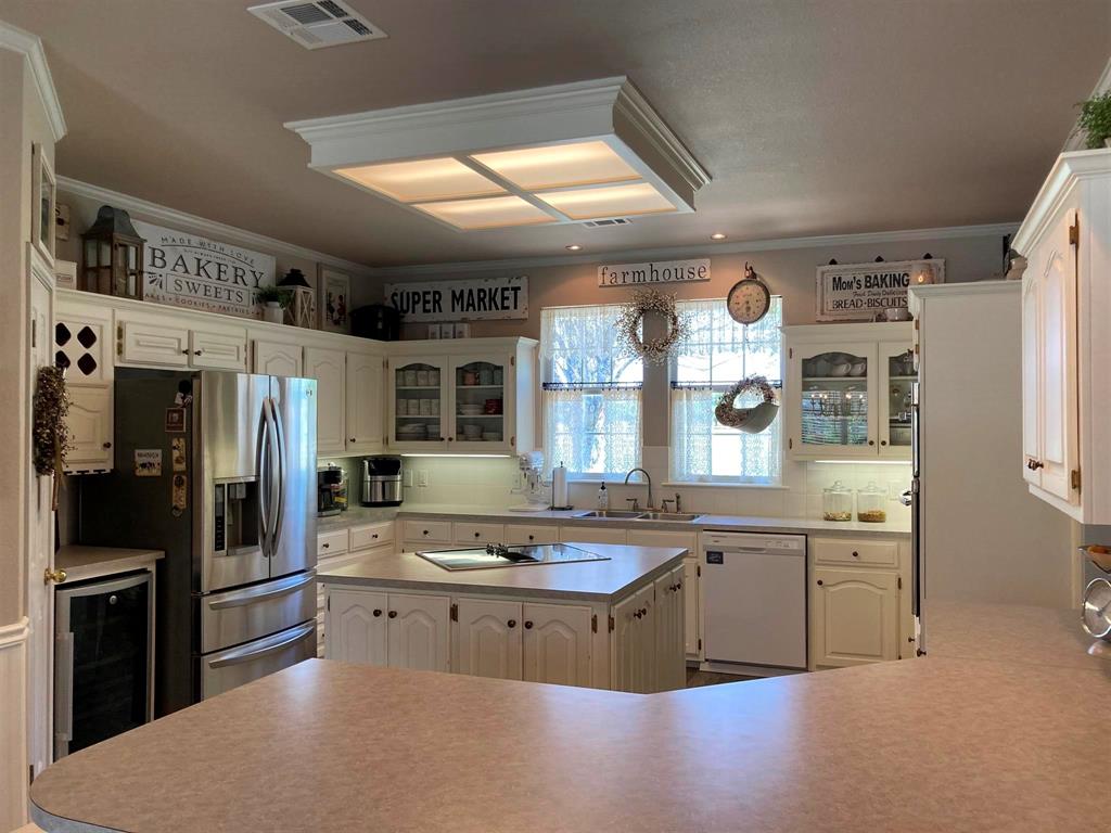 142 Hickory Valley Lane Waco, TX 76705 - Photo 12 of 33 a kitchen with stainless steel appliances granite countertop a sink and cabinets
