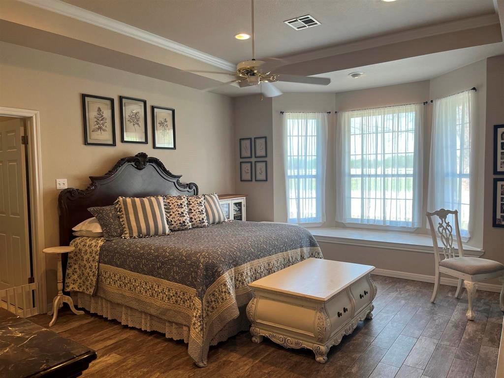 142 Hickory Valley Lane Waco, TX 76705 - Photo 15 of 33 a living room with a bed furniture and a chandelier