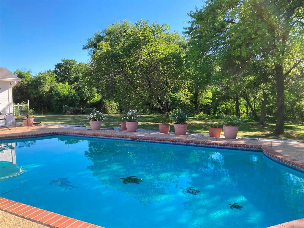 142 Hickory Valley Lane Waco, TX 76705 - Photo 24 of 33 a view of a swimming pool with an outdoor space and seating area
