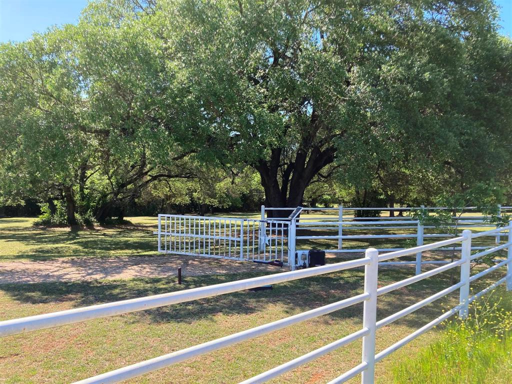 142 Hickory Valley Lane Waco, TX 76705 - Photo 30 of 33 a view of a yard with wooden fence and large trees