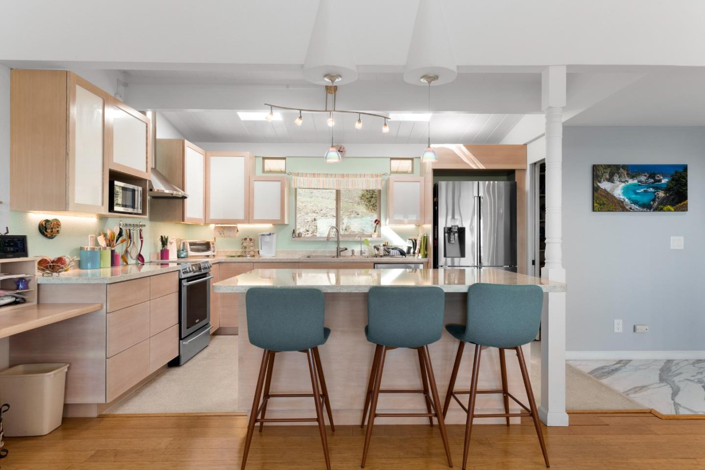 490 Amigo Road Soquel, CA 95073 - Photo 12 of 71 a kitchen with stainless steel appliances granite countertop a stove top oven a sink dishwasher a dining table and chairs with wooden floor